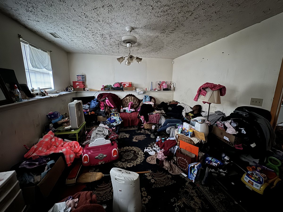 Den filled with belongings before clearing