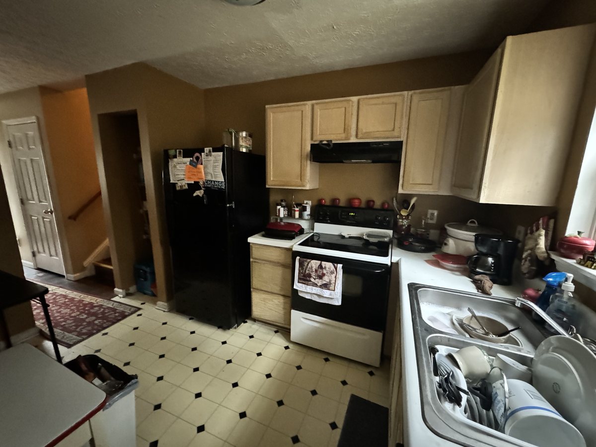 The Wendell kitchen as we found it, with dated cabinets and worn vinyl flooring