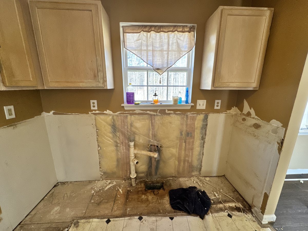 Kitchen wall opened up showing water damage